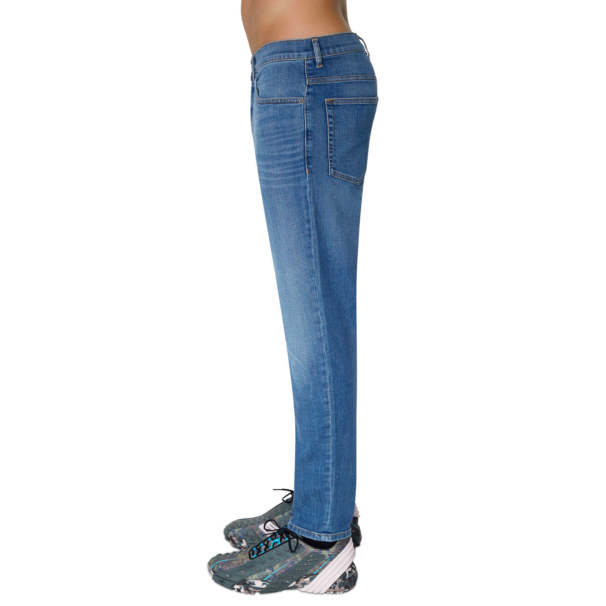 Side view of Diesel D-Fining 09D47 Tapered Fit Jeans in Medium Blue