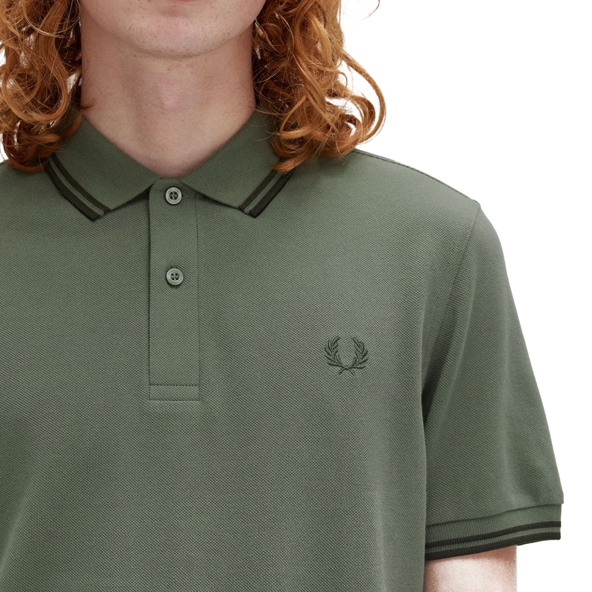 Close-up of Laurel Wreath embroidery on Fred Perry The Fred Perry Shirt for Men in Laurel Wreath Green/Night Green