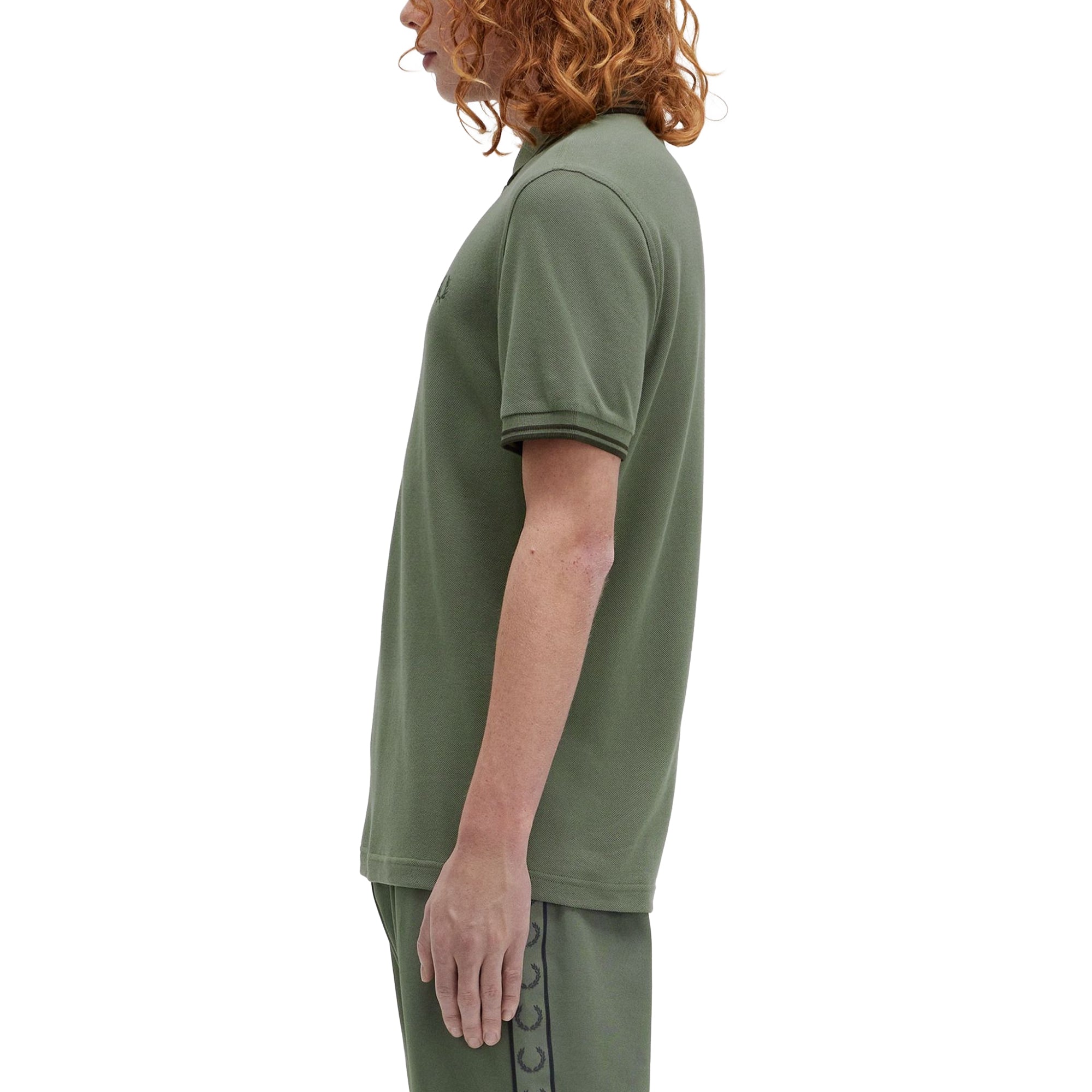 Side model shot of Fred Perry The Fred Perry Shirt for Men in Laurel Wreath Green/Night Green