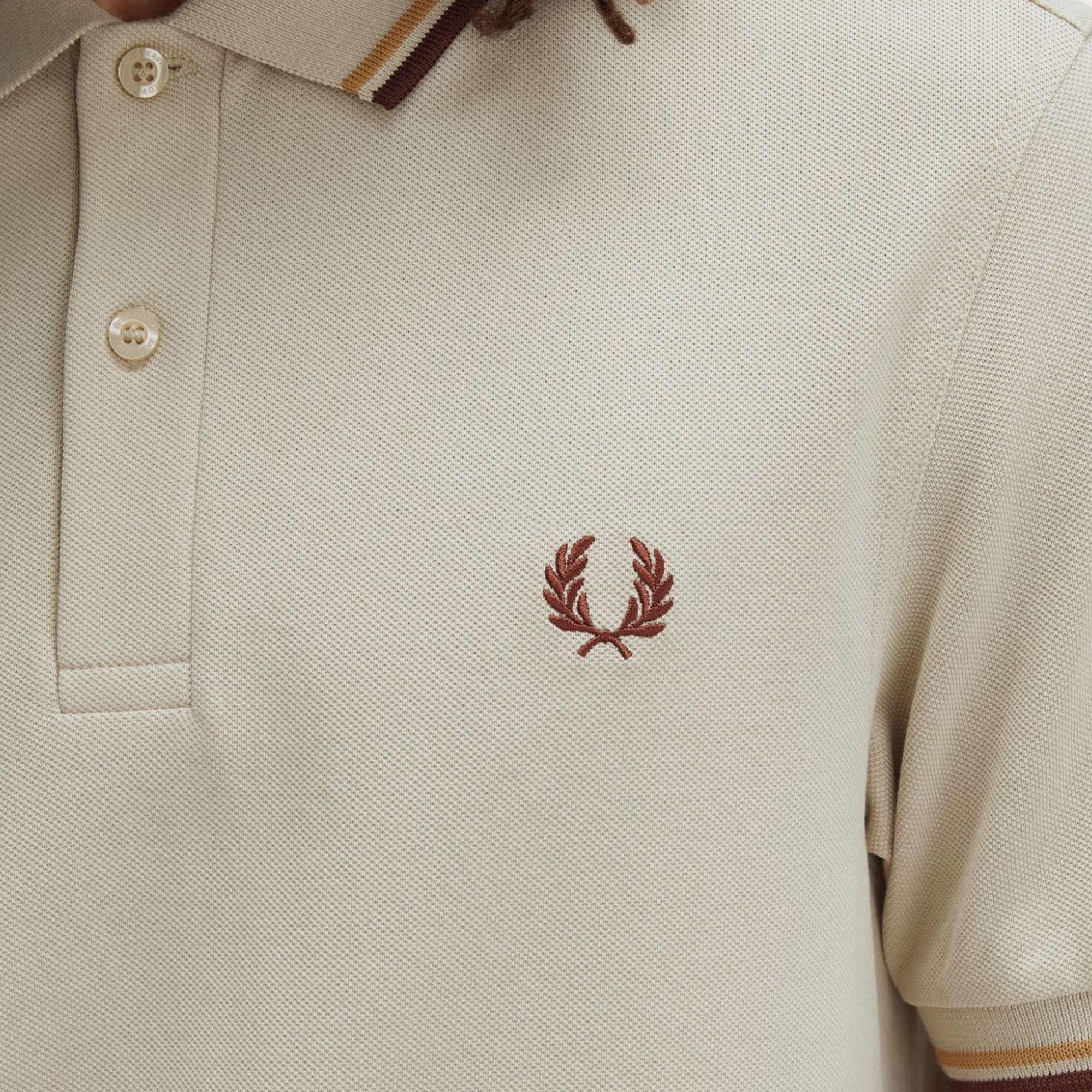 Close-up of Laurel Wreath embroidery on Fred Perry The Fred Perry Shirt for Men in Oatmeal/Honeycomb/Whisky Brown